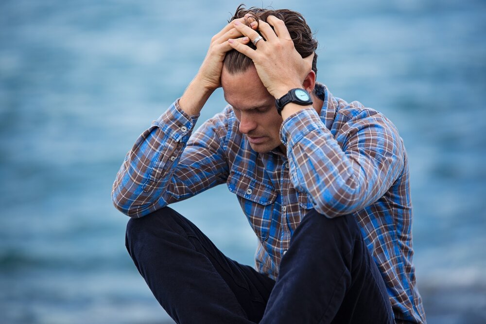 man-in-blue-and-brown-plaid-dress-shirt-touching-his-hair-897817.jpg