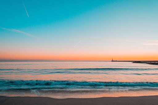 tranquil beach with orange and teal colors
