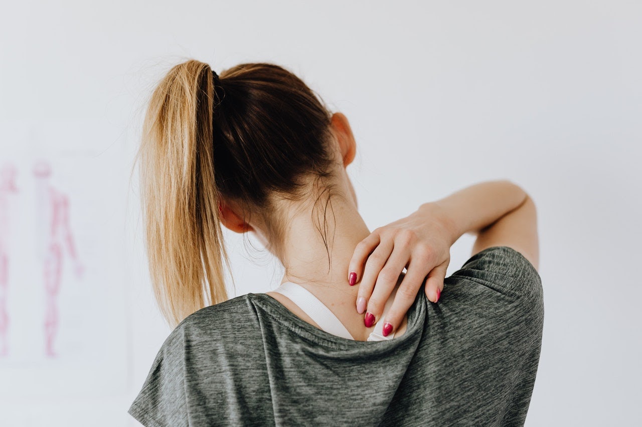 teen holding neck and dealing with emotional pain from abusive relationship