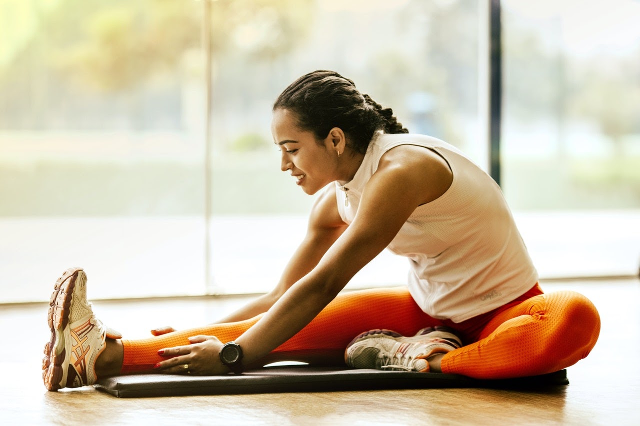 woman stretching in dance floor room