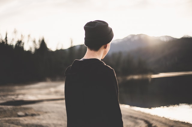 photo-of-a-man-with-back-turned-from-camera-staring-at-mountains